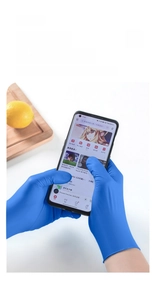 Touchscreen compatible blue nitrile gloves showing precise smartphone operation detail