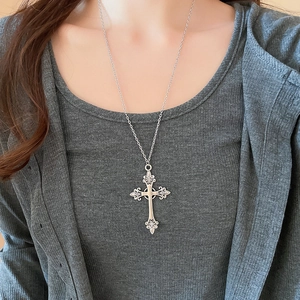 Silver vintage cross necklace with diamond detail shown on a model for a stylish look