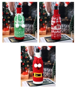 Close-up of knitted Christmas wine bottle covers with reindeer and snowflake patterns