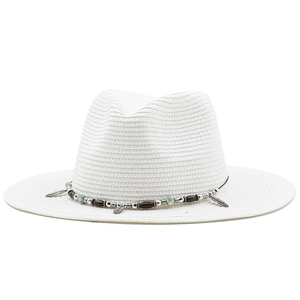 White straw fedora hat with ethnic beaded band and feather charms on white background