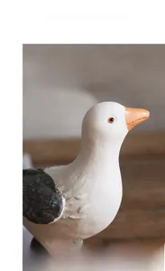Close-up of a resin seagull figurine showing vintage distressed texture and carved feathers