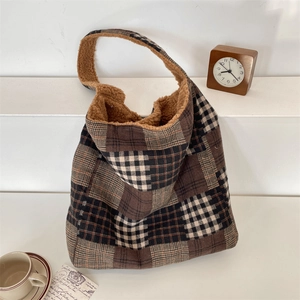 Close-up of cozy plaid tote bag with brown wool lining and textured fabric detail