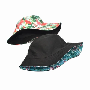 Detail of reversible bucket hat showing flamingo tropical print and solid black cotton side
