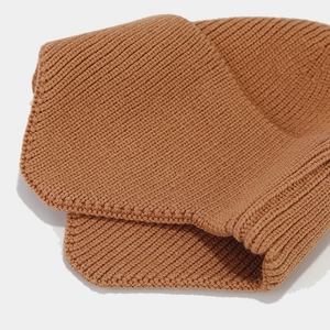 Detailed macro view of the premium rib-knit texture on a warm brown winter beanie hat