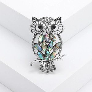 Vintage owl brooch with hollow silver metal design and colorful abalone shell inlay