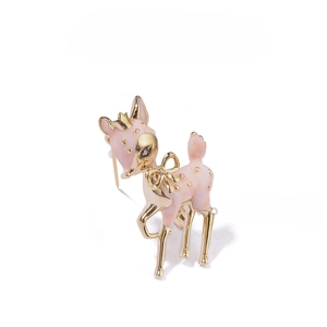 Macro detail of a 3D pink enamel deer brooch featuring a gold crown and crystal eye