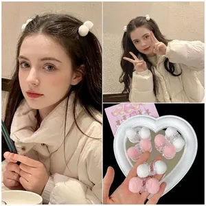 Cute pink and white plush ball hair clips set for women shown in multiple styling views