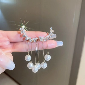 Macro detail of snowflake zircon stud with elegant pearl tassels and shimmering finish