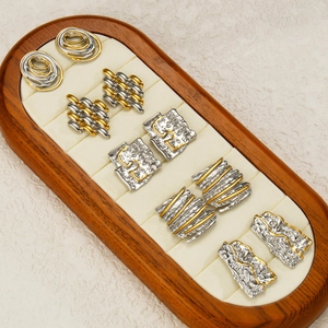Two-tone stainless steel stud earrings set with textured geometric irregular designs