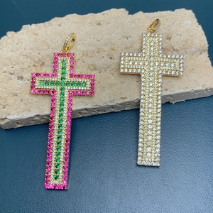 Detailed macro view of 18k gold cross pendants with multi-color zircon stones