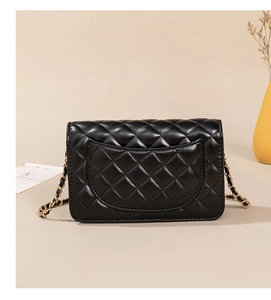 Rear view of black quilted leather shoulder bag with golden woven chain strap and pocket