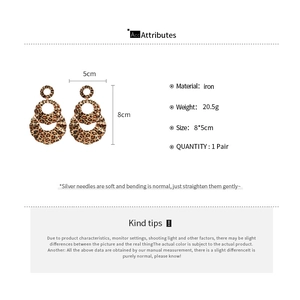 Detail view of tiered leopard print earrings with product dimensions and material specs