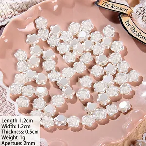 Detailed view of white rose shaped pearl beads with holes for DIY jewelry making