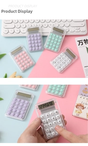 Macro detail of mini transparent calculator showing macaron buttons and LCD screen
