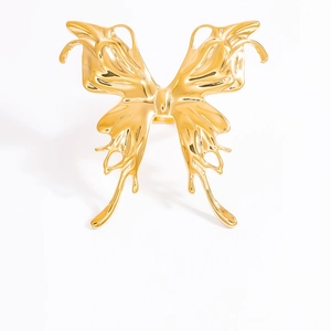 Detailed view of a golden butterfly ring featuring polished metallic finish on white background
