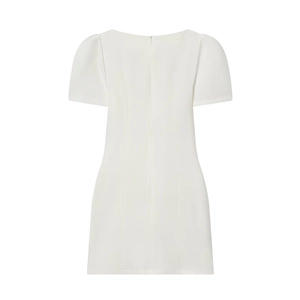 Detailed back view of white pleated dress featuring puff sleeves and hidden zipper