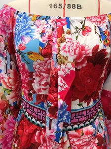 Detail of colorful floral print and Greek fret border on vintage v-neck dress