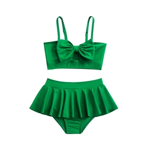 Two-piece bright green girls' swimsuit with bow tie top and ruffled skirt bottom