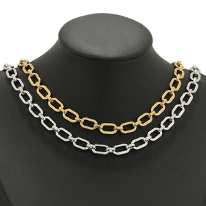 Detail of 304 stainless steel 18K gold and silver flattened cross chain on a black bust