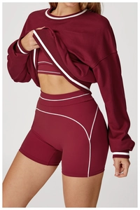 Detail of burgundy three-piece sportswear set with white contrast piping accents