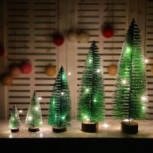 Miniature green Christmas trees with LED lights and wood bases in various sizes