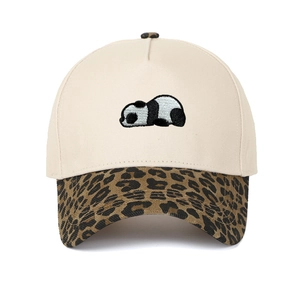 Detailed embroidery of a lying panda on a cream and leopard print baseball cap