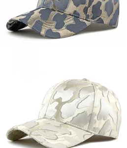 Detailed view of jacquard leopard texture on beige and charcoal baseball caps