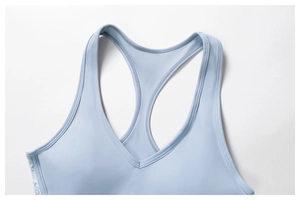 Close-up of light blue lace racerback yoga bra showing V-neck and fine stitching details