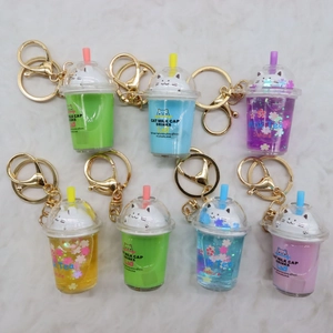 Collection of seven mini cat milk tea acrylic keychains in various vibrant colors