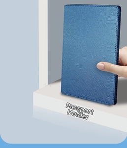 Close-up of blue Saffiano leather passport holder with multi-card slots and vertical flap