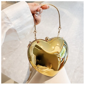 Detailed view of a metallic gold heart-shaped handbag with an elegant chain strap