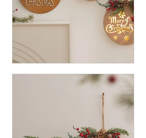 Close-up of wooden Merry Christmas hanging sign with pine branches and red berries