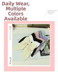 Detail shot of six colorful handmade fabric bow hair clips in pastel and neutral tones