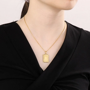 Detail of 18k gold plated rectangle pendant with engraved letter A on a necklace