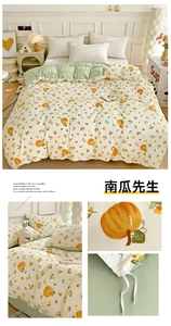 Close-up of cream floral duvet cover set with orange pumpkin patterns and cotton texture