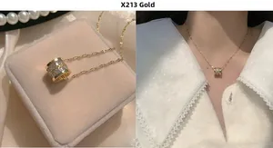 Detail of gold cylinder pendant necklace with zircon inlay and sparkling chain style