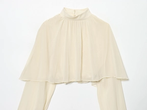Detailed view of the chiffon cream high-neck blouse with elegant back button closure