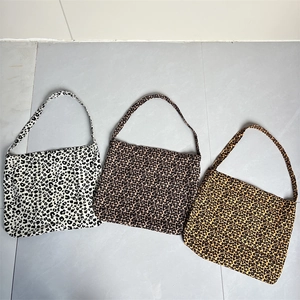 Three leopard print canvas tote bags in white, light brown, and ginger yellow patterns