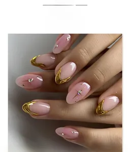 Detail of pink press on nails with 3D gold French tips and sparkling star accents