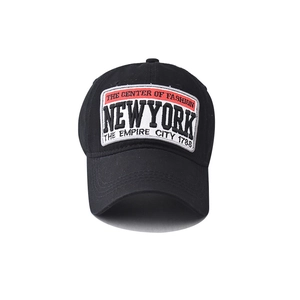 Detailed close-up of NEW YORK embroidered patch on a black cotton baseball cap