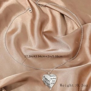 Detail of angel wing heart necklace with 'A piece of my heart has wings' engraving