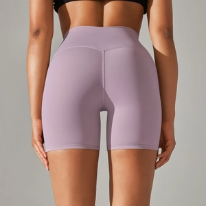 Detail of purple high-waisted yoga shorts featuring seamless peach butt lift design