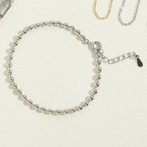 Close-up of silver beaded bracelet with adjustable extension chain and lobster clasp