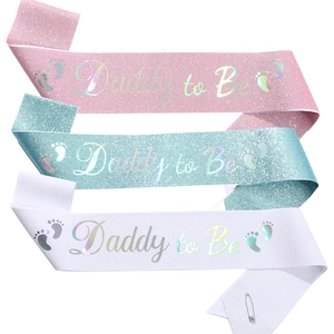 Glittery Daddy to Be sashes in pink, blue, and white for baby shower celebrations