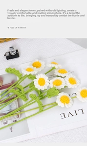 Close-up of handmade knitted daisy bouquet with white petals on a soft background