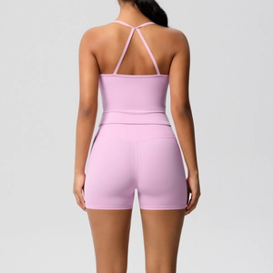 Close-up of lavender yoga set featuring cross back sports bra and high-waisted shorts