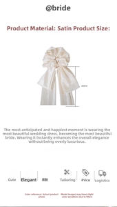 Detail of cream silk satin scrunchie with 50cm long ribbons on white background