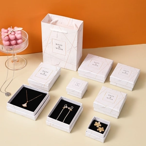 Luxury marble pattern jewelry box set with gold accents and matching gift bag