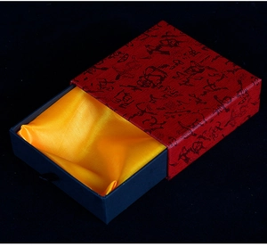 Premium drawer-style gift box with red textured cover and golden silk lining detail