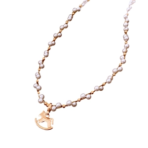 Elegant gold-plated rocking horse pendant necklace with white pearl beads for women